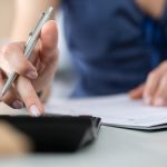 Close up of female accountant or banker making calculations